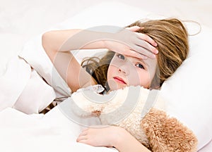 Sick little girl lying in the bed