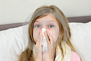 A sick little girl takes medication and eats fruit.