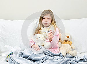 A sick little girl takes medication and eats fruit