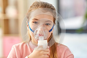 Sick little girl wearing oxygen mask