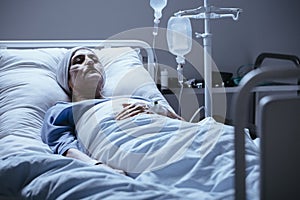 Sick and lonely senior woman with leukemia during chemotherapy i