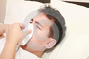 Sick man blowing his nose