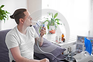 A sick man breathes through an inhaler mask