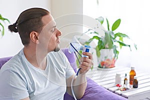 A sick man breathes through an inhaler mask