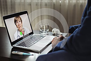 Sick man chatting with doctor while having video call during isolation quarantine. Healthcare and medical concept