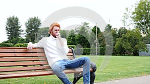 Sick Man Coughing, Sitting in Park, Red Hairs and Beard