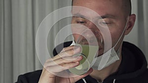 Sick man drinking effervescent antipyretics pill dissolved in glass of water. Health care slow motion stock footage