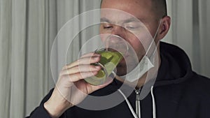 Sick man drinking effervescent antipyretics pill dissolved in glass of water. Health care slow motion stock footage