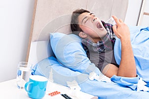 The sick man with flu lying in the bed
