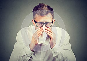 Sick man having flu sneezing