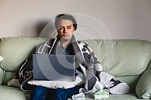 Sick man hold tissue around nose