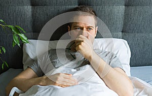 Sick man with inhalator mask on the face in bed