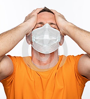 Sick man in mask. Man suffering from headach over white background photo