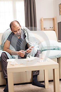 Sick man reading the prospect for his pills