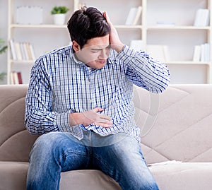 Sick man suffering at home from infection and bad stomach