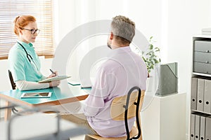 Sick man talking to urologist