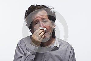 Sick man with tissue, horizontal