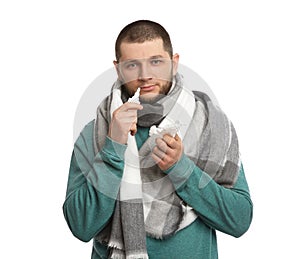 Sick man with tissue and nasal spray on white background