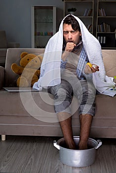 The sick man washing his feet at home