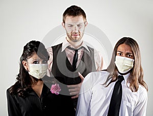 Sick man and worried coworkers in masks