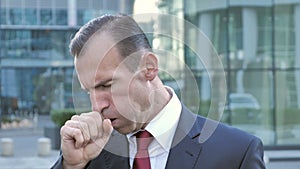 Sick Middle Aged Businessman Coughing