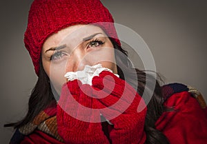 Sick Mixed Race Woman Blowing Her Sore Nose With Tissue