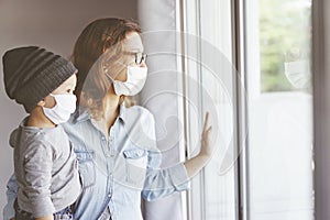 Sick mother and her son looking through the window