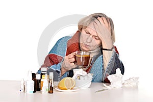 Sick old woman drinks tea