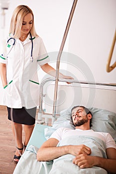 Sick Patient in hospital room next to nurses