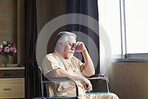 A sick person on a wheelchair in ward. Senior man in wheelchair with doctor in hospital