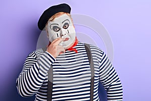 Sick poor man treating his nose, isolated blue background