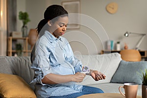 Sick Pregnant Black Woman Measuring Temperature Having Fever At Home