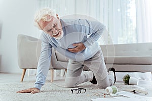 Sick senior man falling from heart attack