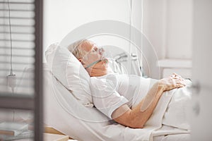 Sick Senior Man in Hospital Bed