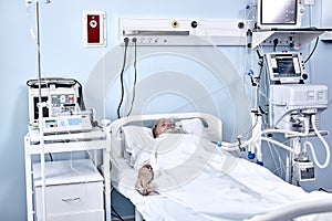 Sick Senior Patient Rests on Bed, Man Sleeping in Modern Hospital Ward.