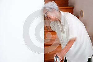 Sick senior woman suffering from dizziness,giddiness,attack of vertigo,sensation of whirling,loss of balance during standing up