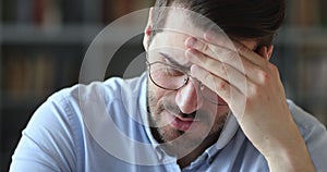 Sick stressed man feeling strong headache, close up view