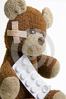 Sick Teddy Bear with pills.