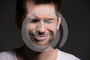 Sick and tired. Portrait of men with closed eyes expressing negativity while isolated on grey