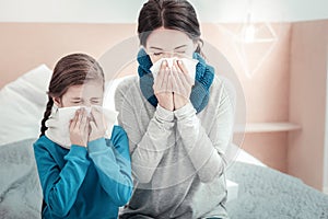 Sick unhappy natives sitting and sneezing.