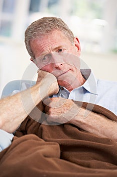 Sick, unhappy older man at home