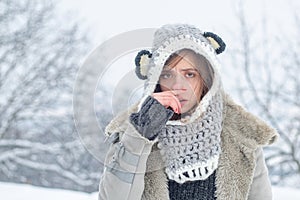 Sick in winter. Cold flu winter season, runny nose. Showing sick woman sneezing at winter park. Young woman blowing nose