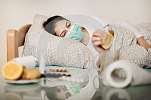 Sick woman in bed.Pneumonia disease.Flu infected patient with protective mask suffering from symptoms of coronavirus illness.