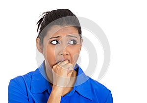 Sick woman biting her hand and looking to side anxious
