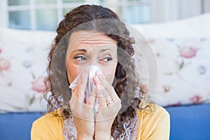 Sick woman blowing her nose