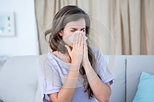 Sick woman blowing her nose