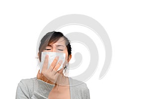 Sick woman blowing her nose isolated.