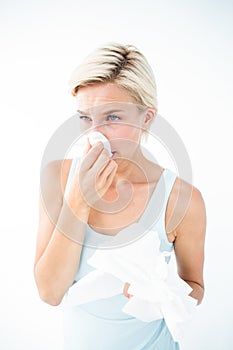 Sick woman blowing her nose