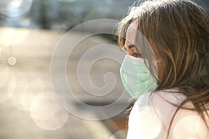 Sick woman of corona virus looking through the window