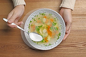 Sick woman eating fresh homemade soup to cure flu